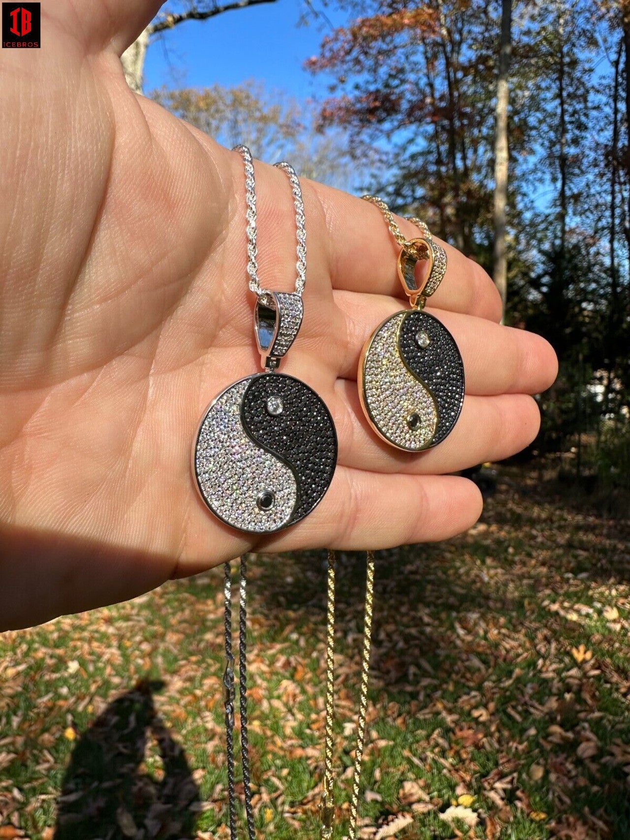 Men Showing 14k White Gold and 14k Yellow Gold Ying Yang Moissanite Pendant Necklace With Rope Chain On Hand