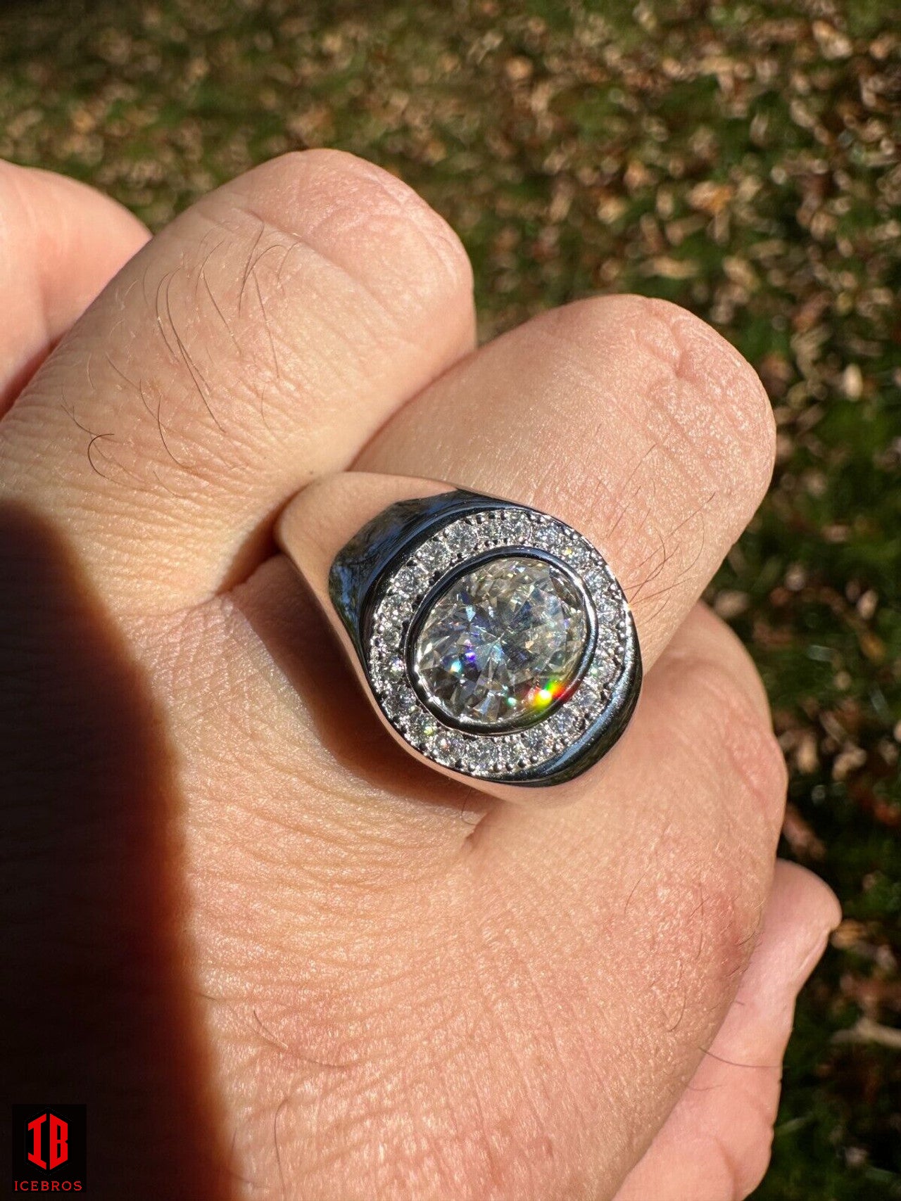 A Men wearing White gold ring with Oval Cut Moissanite diamond in hand