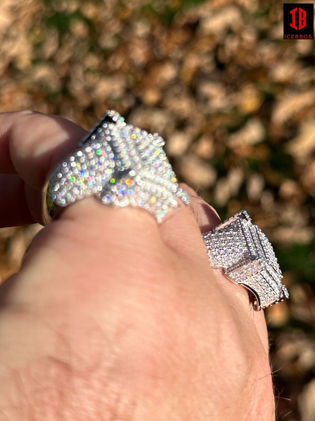 A Man Showing Sides of Shinning White Gold Iced Moissanite Ring