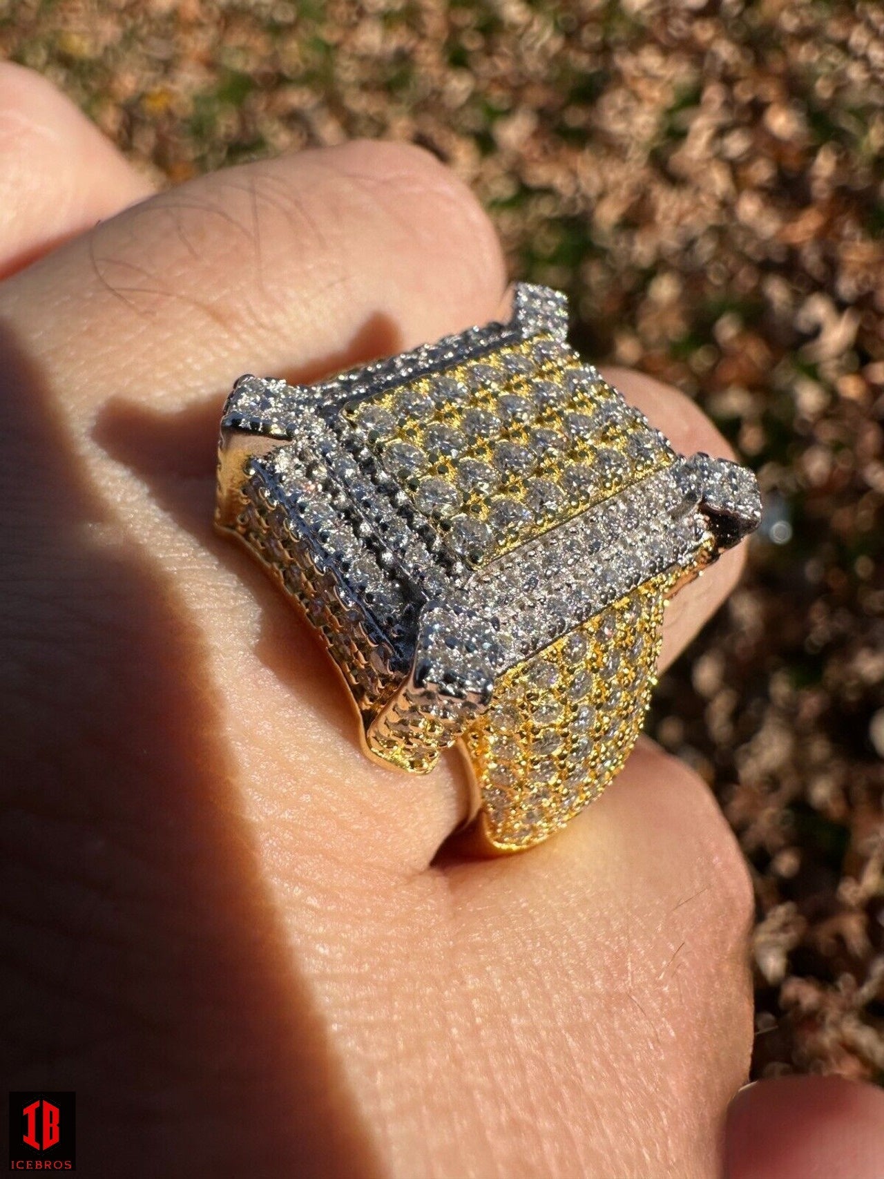 A person's hand showcasing a stunning 14k gold and Moissanite diamond ring, adding elegance and sparkle to their appearance.  