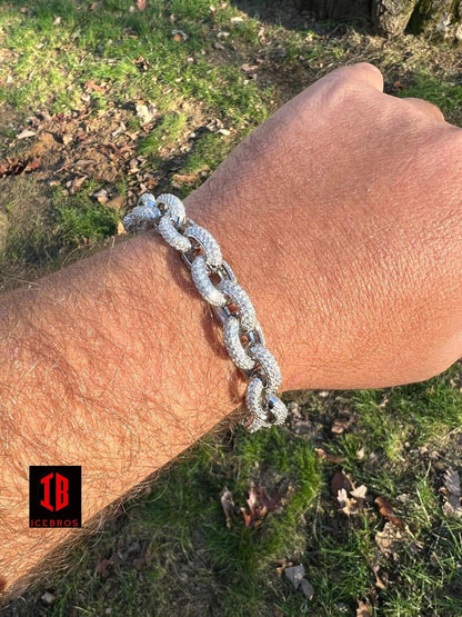 A gentleman adorns his arm with a resplendent White Gold Rolo Link  bracelet, exuding elegance and sophistication. A moissanite masterpiece.