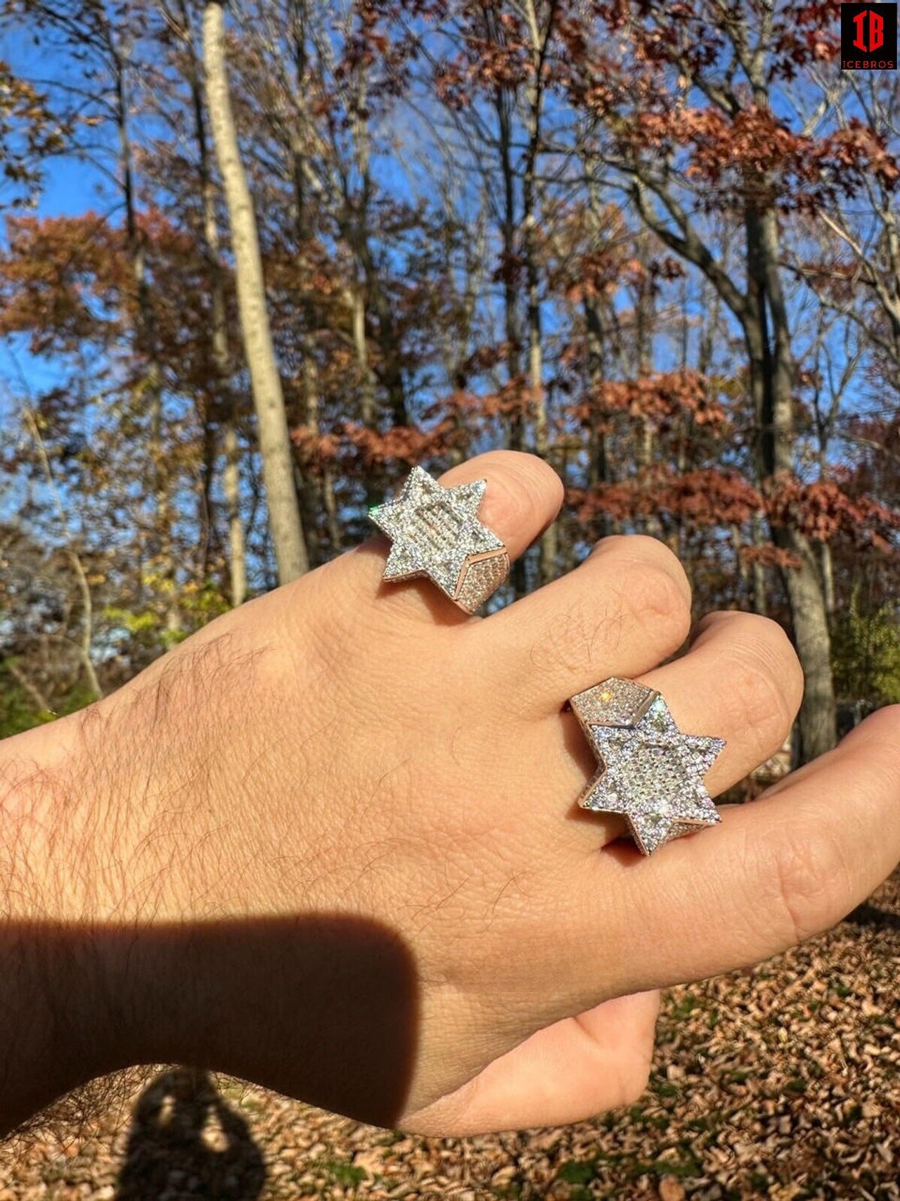 a man wearing two 4.3 carat moissanite rings in different finger of different sizes