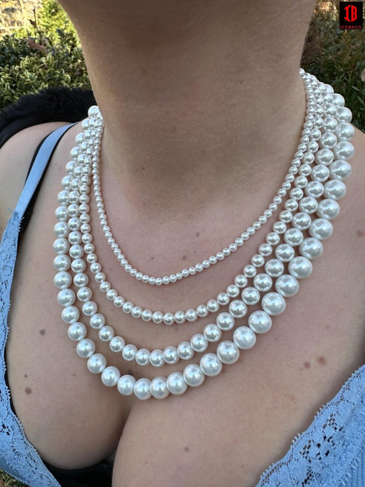 Women Wearing Different Sizes of White Cultured Pearl Necklace  On Women neck 