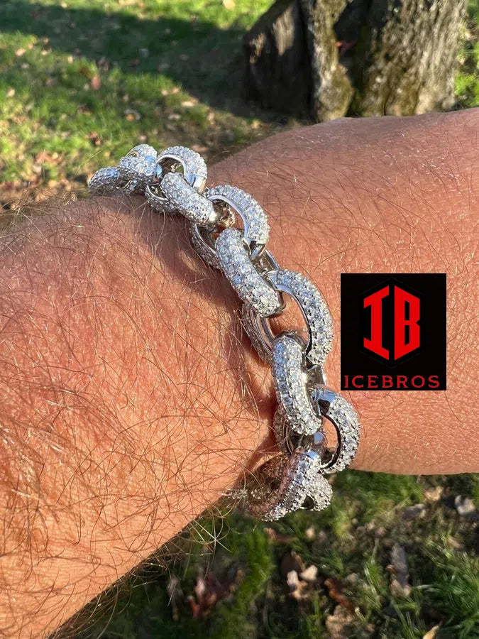 A man showcasing a 925 sterling silver silver chain bracelet elegantly adorning his arm, adding a touch of sophistication to his attire.