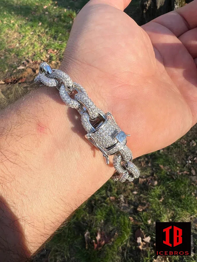 A gentleman flaunts a mesmerizing silver chain bracelet, adorned with the brilliance of moisstanite, on his elegant arm.