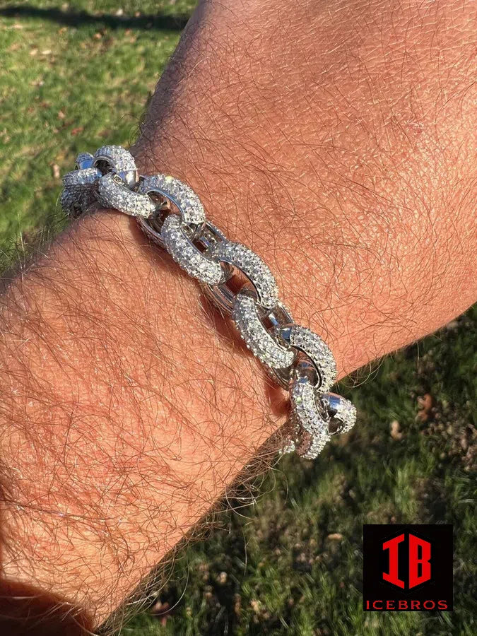 A gentleman adorns his arm with a resplendent moissanite bracelet, gleaming in silver radiance.