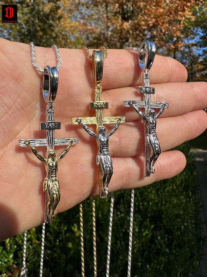 A person showcasing three unique necklaces adorned with crosses, including a Cross Jesus Pendant.