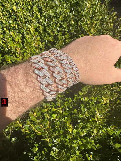  men's hand adorned with a stunning 14k Rose & White Gold Diamond Moissanite Miami Cuban Link Bracelet, showcasing its exquisite craftsmanship and timeless design .