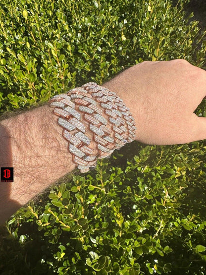 men's hand adorned with a stunning 14k Rose & White Gold Diamond Moissanite Miami Cuban Link Bracelet, showcasing its exquisite craftsmanship and timeless design .