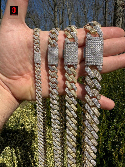 A gold and white two-prong Cuban link chain, available in various sizes. The image shows complete the chain on hand