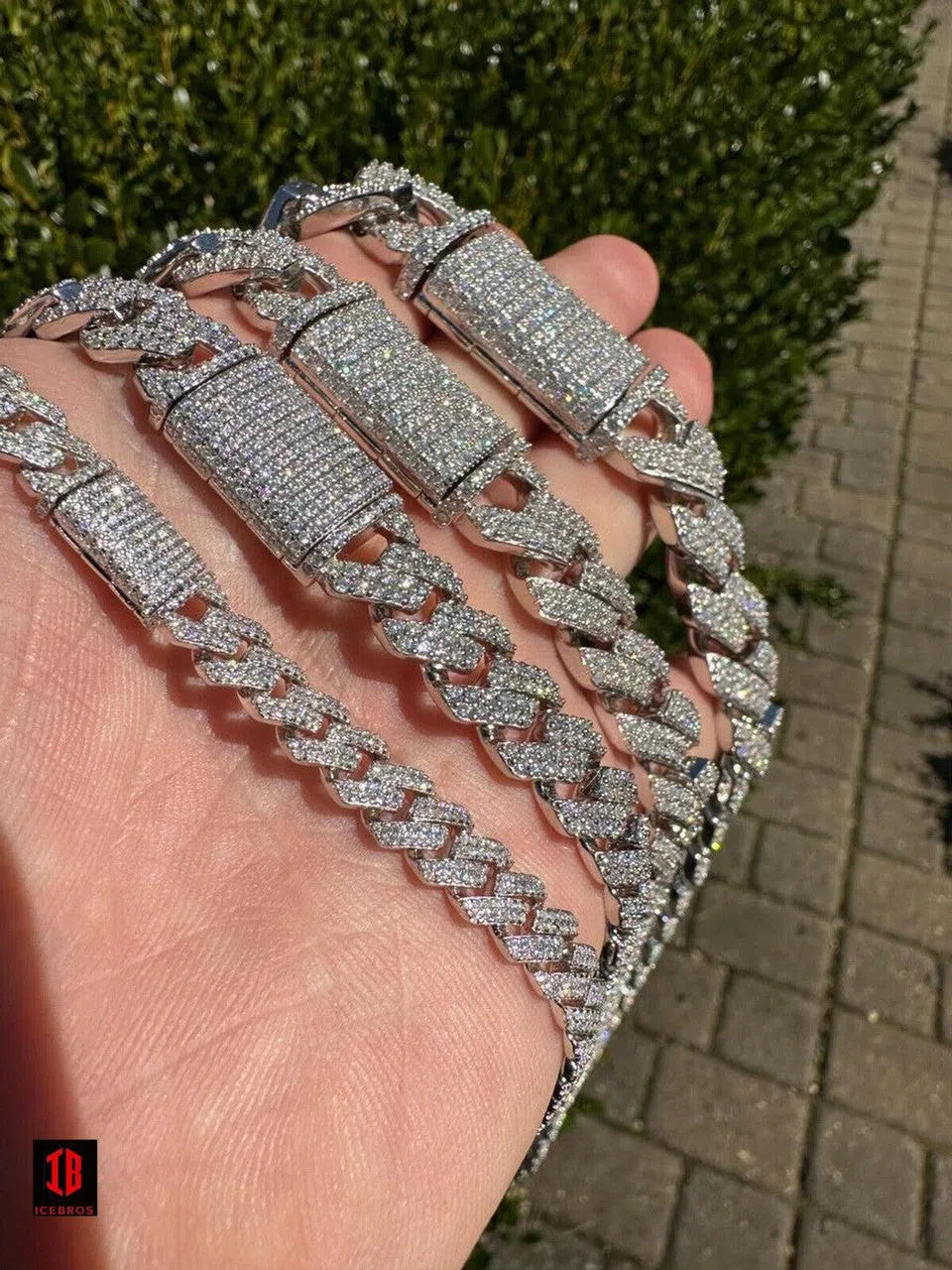  White Gold Cuban Link Chain draped elegantly over a man's hand, showcasing its intricate design and luxurious shine.