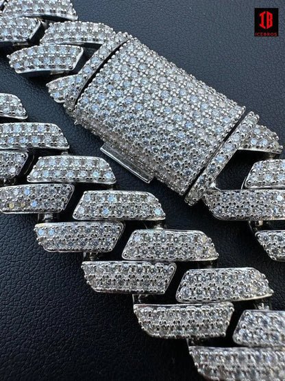  A close-up view of a White Gold Cuban link chain, showcasing its intricate buckle and the frontal design. The chain gleams with a luxurious shine, highlighting its exquisite craftsmanship and elegant aesthetics