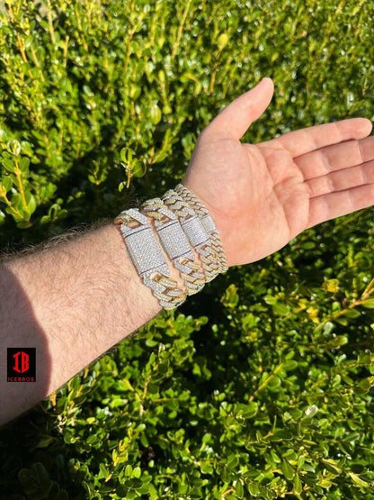 men's hand Wearing  14k Yellow & White Gold Diamond Moissanite Miami Cuban Link Bracelet. The bracelet gleams with its intricate design, combining Yellow and white gold tones, while the diamonds and moissanite stones shimmer, making it a luxurious accessory for various wrist sizes.