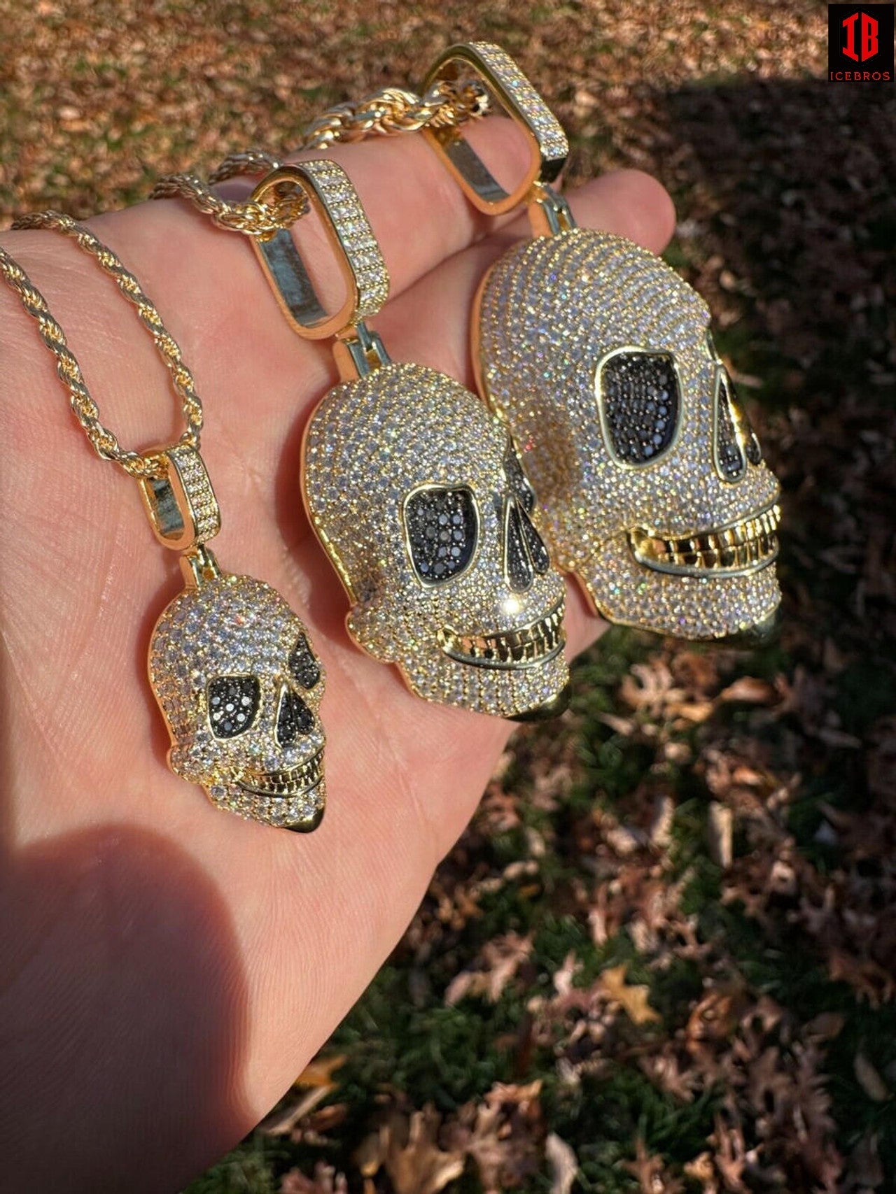 A Man Holding 3 Different Sizes of 14k Gold 3D Skull Pendant With 14k Gold Rope Chain 